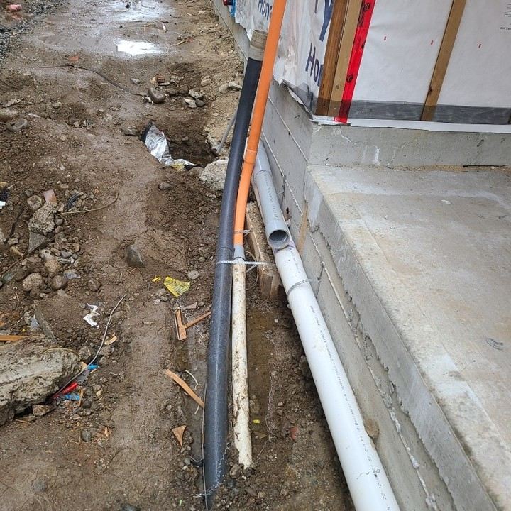 Electrical conduit and service lines run along a new foundation
