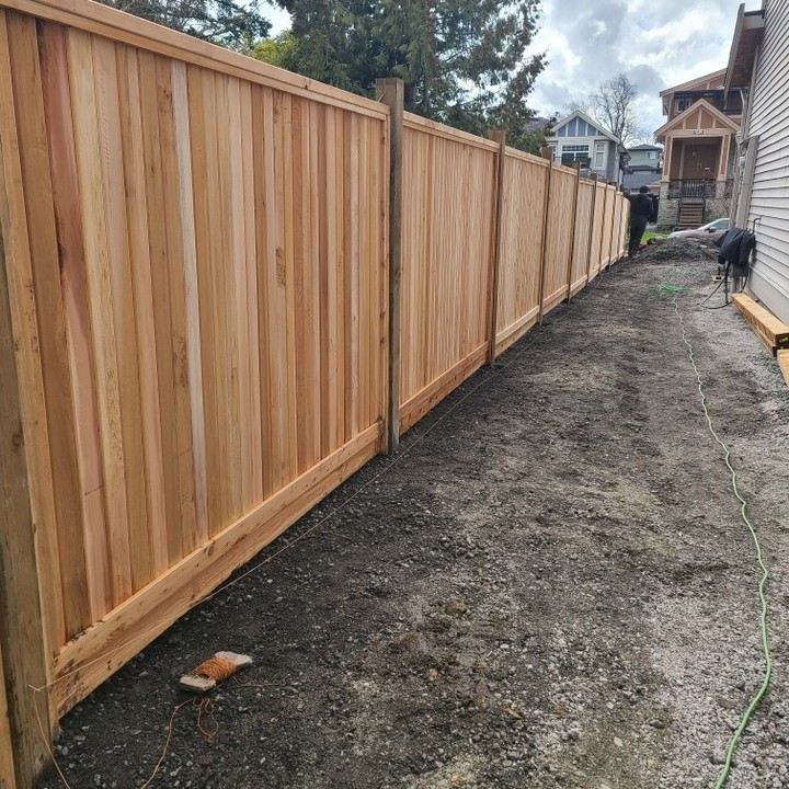 New cedar fence installed along a property line