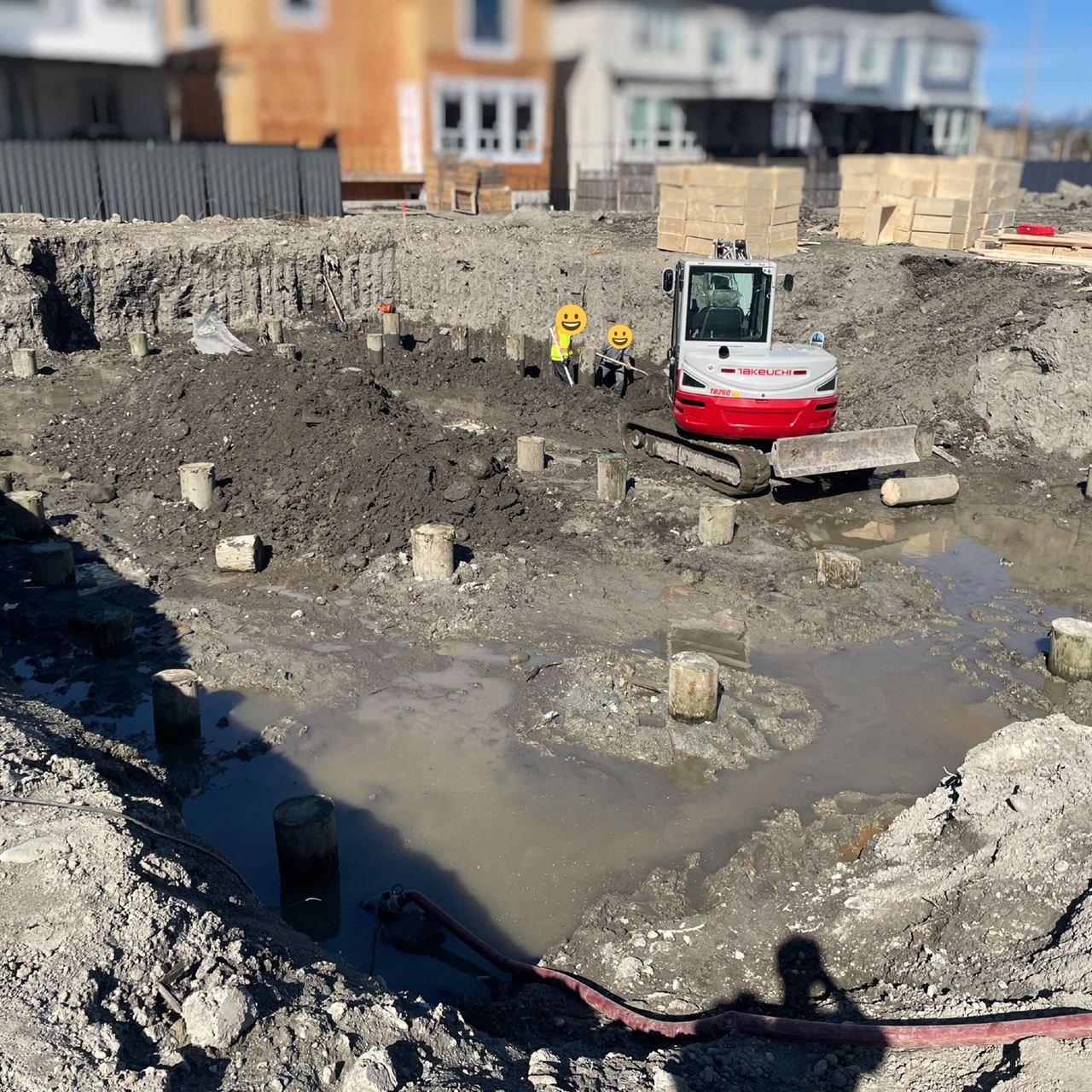 Foundation backfill — skid steer and excavator on site