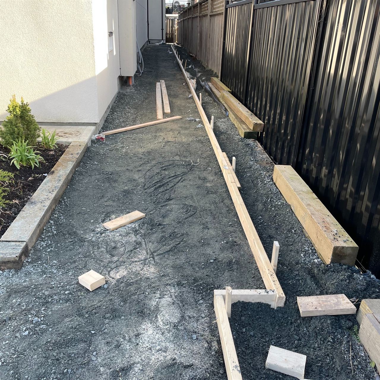 Asphalt paving forming — gravel base and form boards staged for pour