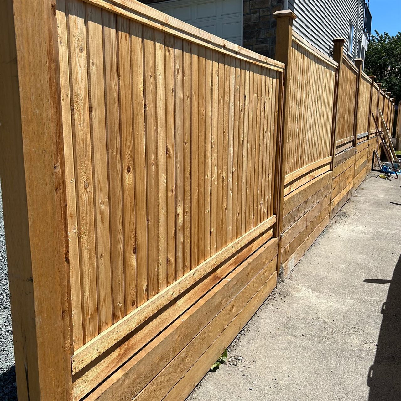 Run of cedar privacy fence on a concrete walk