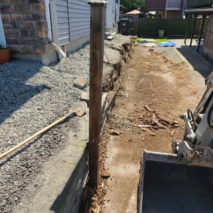 Existing fence removal — old posts and panels cleared for new install