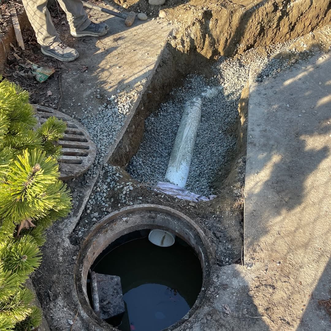 Storm drain pipe connected into a manhole with gravel bedding