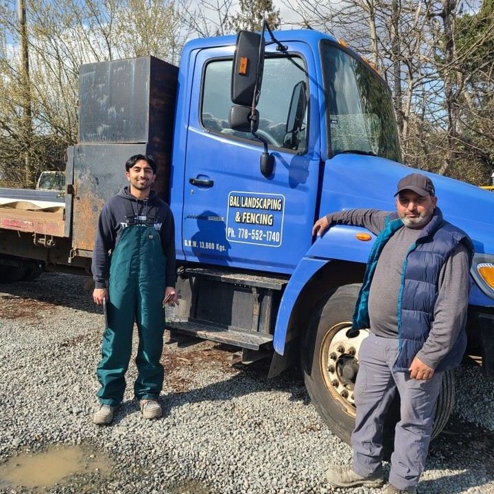 The Bal Landscaping & Fencing team beside their branded blue dump truck